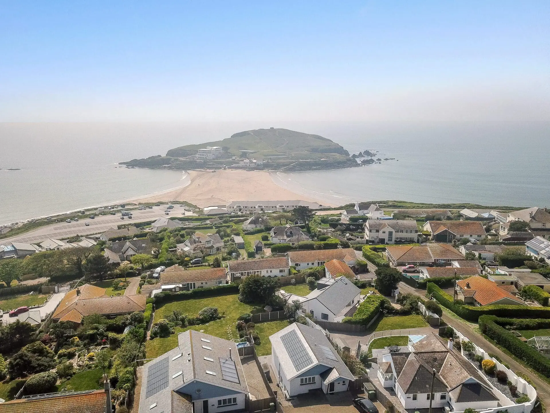 houses with a beach that has sea both sides of it.