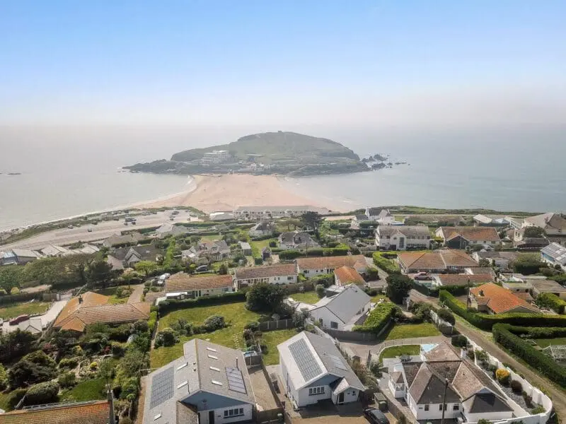 houses with a beach that has sea both sides of it.