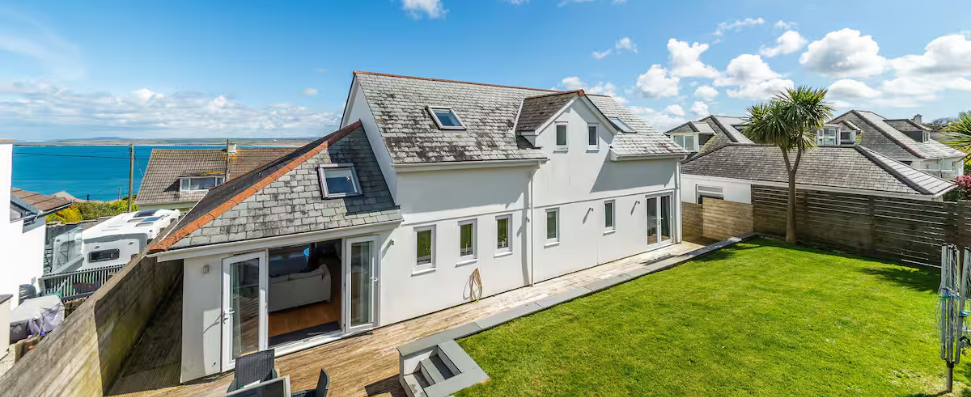 garden, large white house with distant sea views cornwall