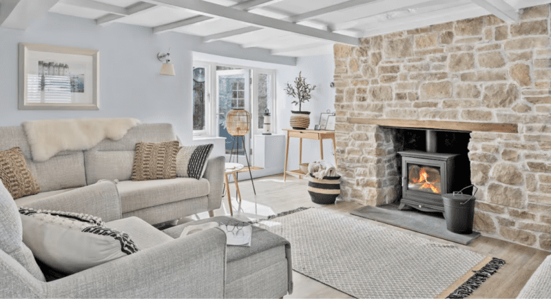living room with stone fireplace