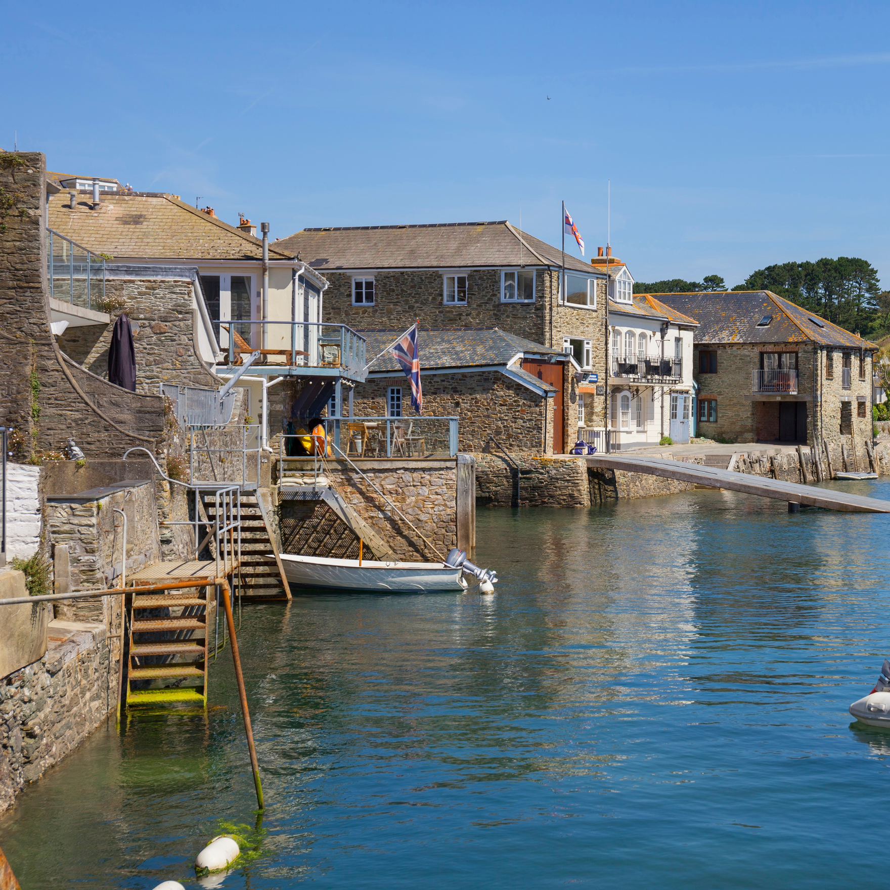 Salcombe harbour edge with holiday homes and boats
