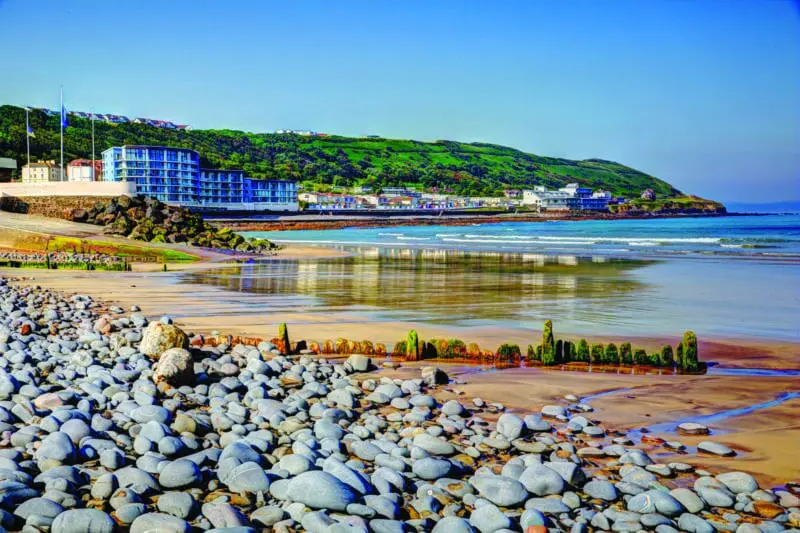 Westward Ho Devon England near Bideford in colourful HDR with pebbles on the beach and blue sea and sky
