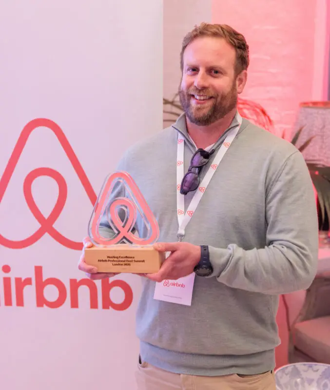 Josh with Airbnb award