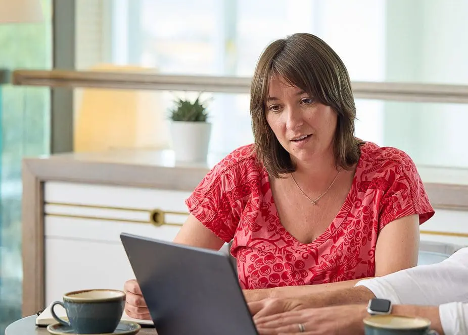 Property owner reviewing financial documents on a laptop