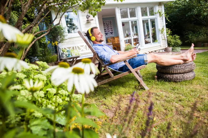 Man relaxing sitting on sun lounger, enjoying the benefits of a co-host