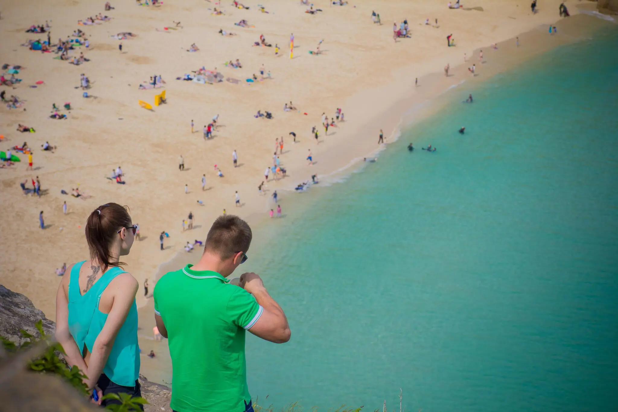 People overlooking a Cornish beach