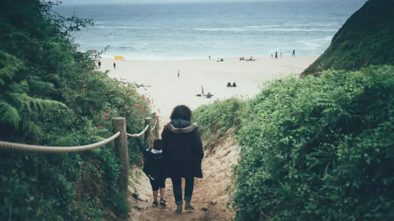 Woman and child walking towards Porthcurno