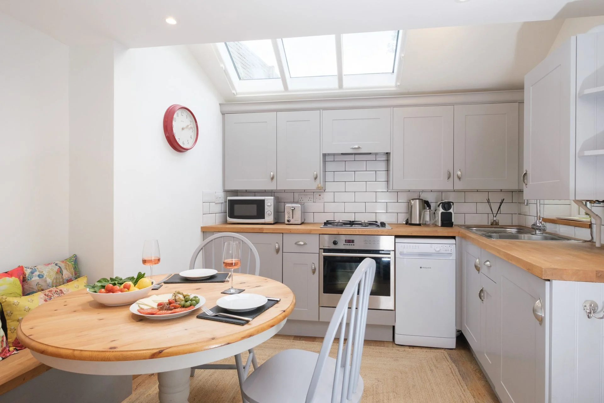 Kitchen and dining table at Crowthers Hill under a large skylight