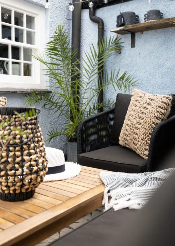 Sheltered courtyard at Quay Cottage with seating and festoon lights