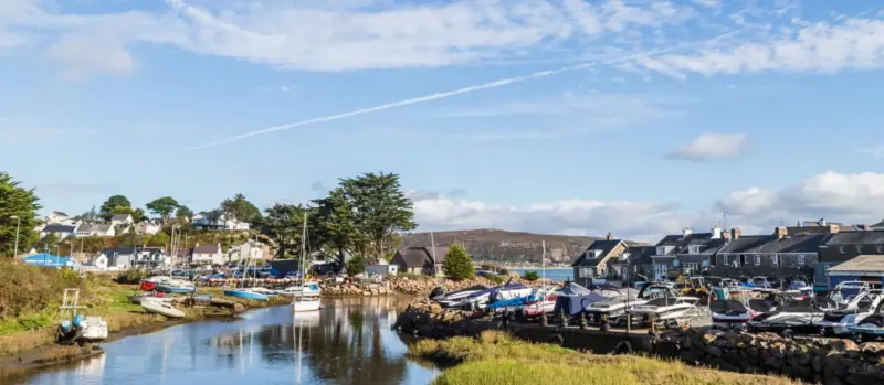 Calm river estuary under dramatic clouds near Abersoch on the Llyn Peninsula, Wales